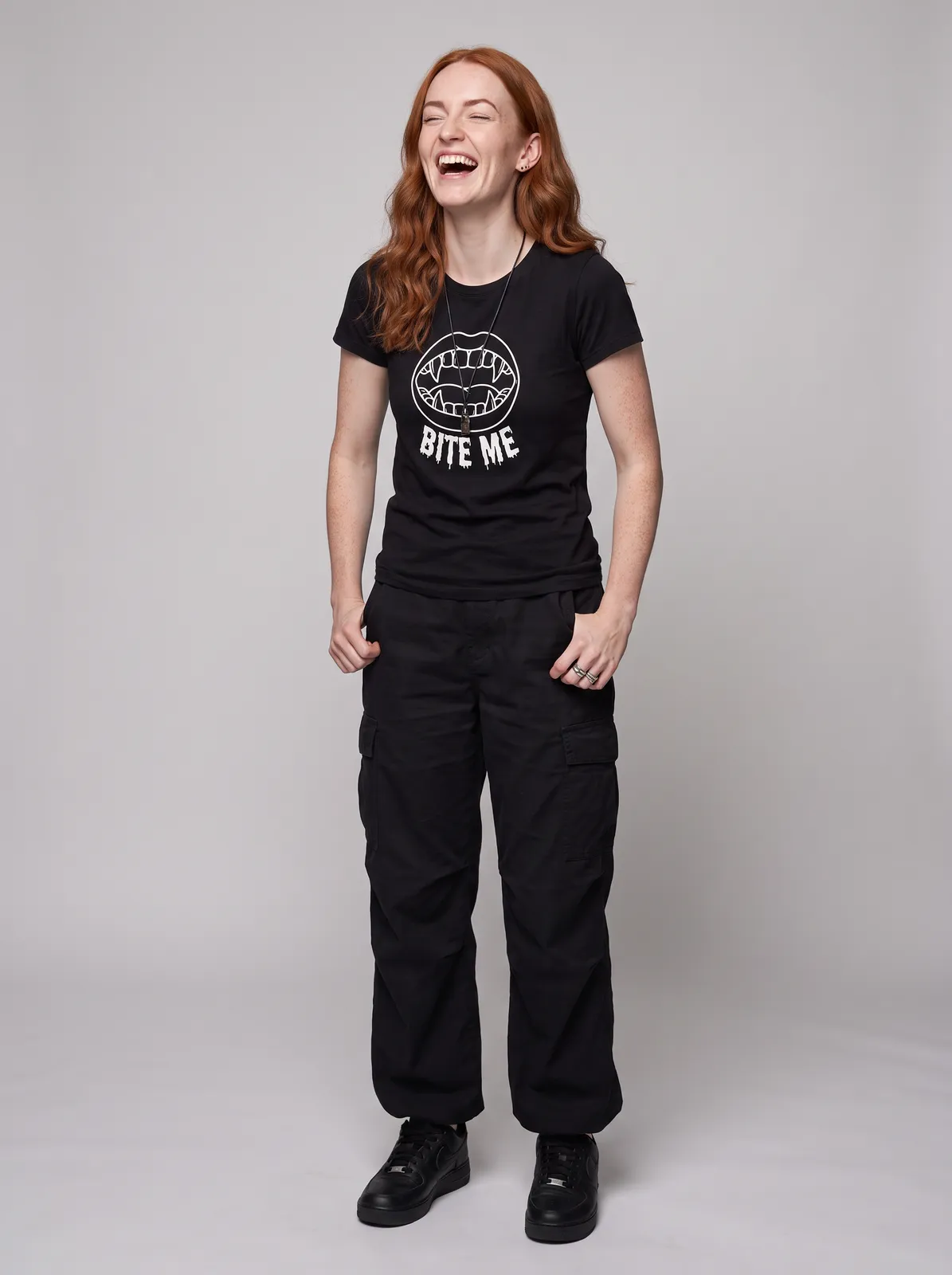Maeve Gallagher wearing the BITE ME Tee in Black, waist up crop