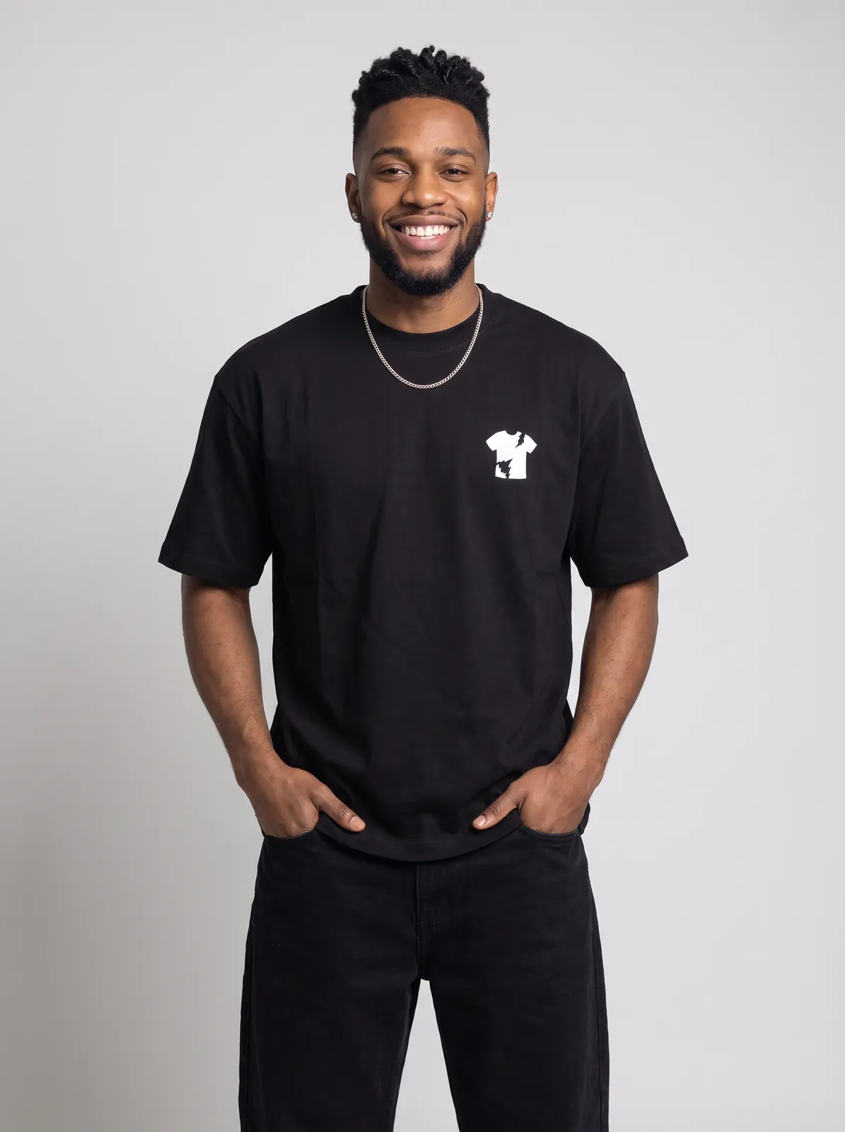 Malik Carter wearing the BLACKOUT Oversized in Black, waist up crop