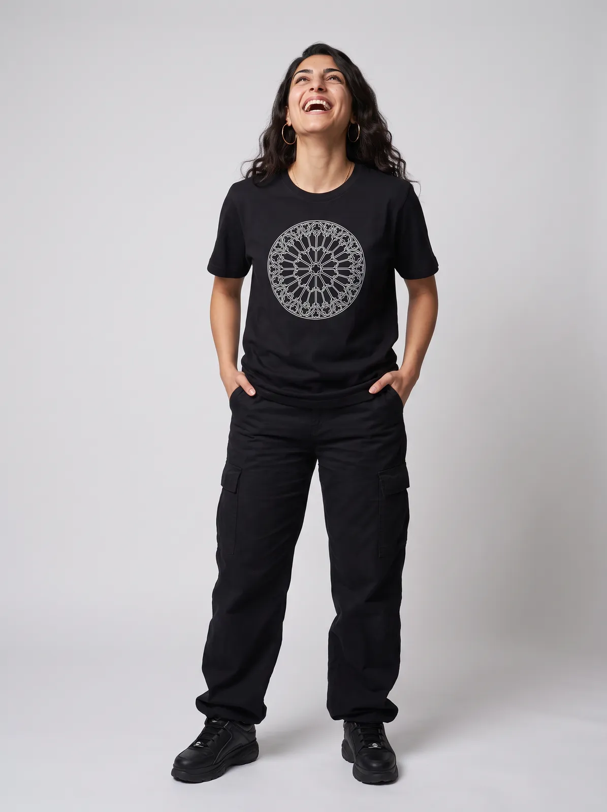 Amara Haddad wearing the CATHEDRAL Tee in Black, waist up crop