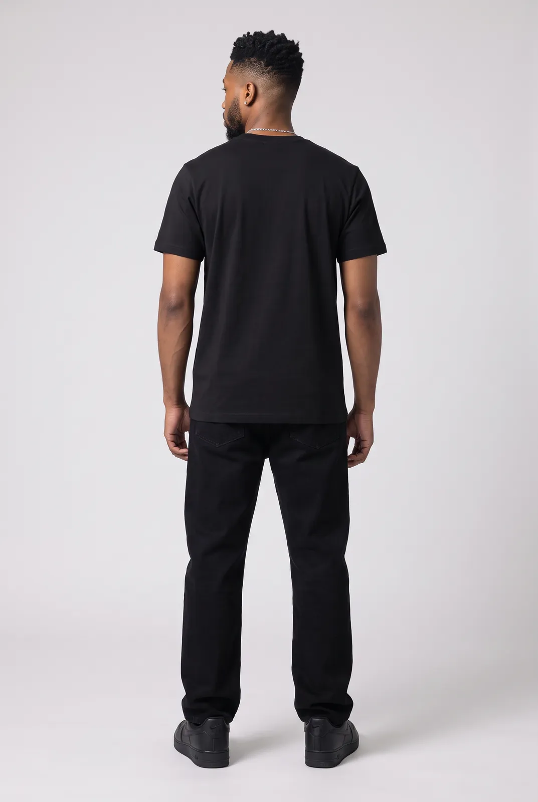 Malik Carter wearing the CITY RATS Tee in Black, back turn