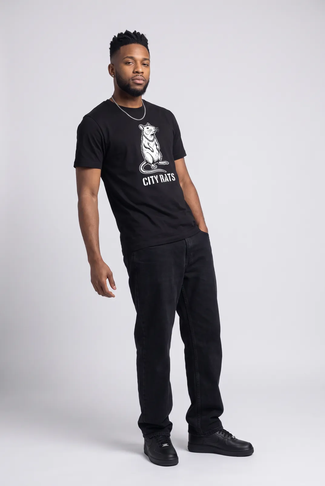 Malik Carter wearing the CITY RATS Tee in Black, three quarter lean