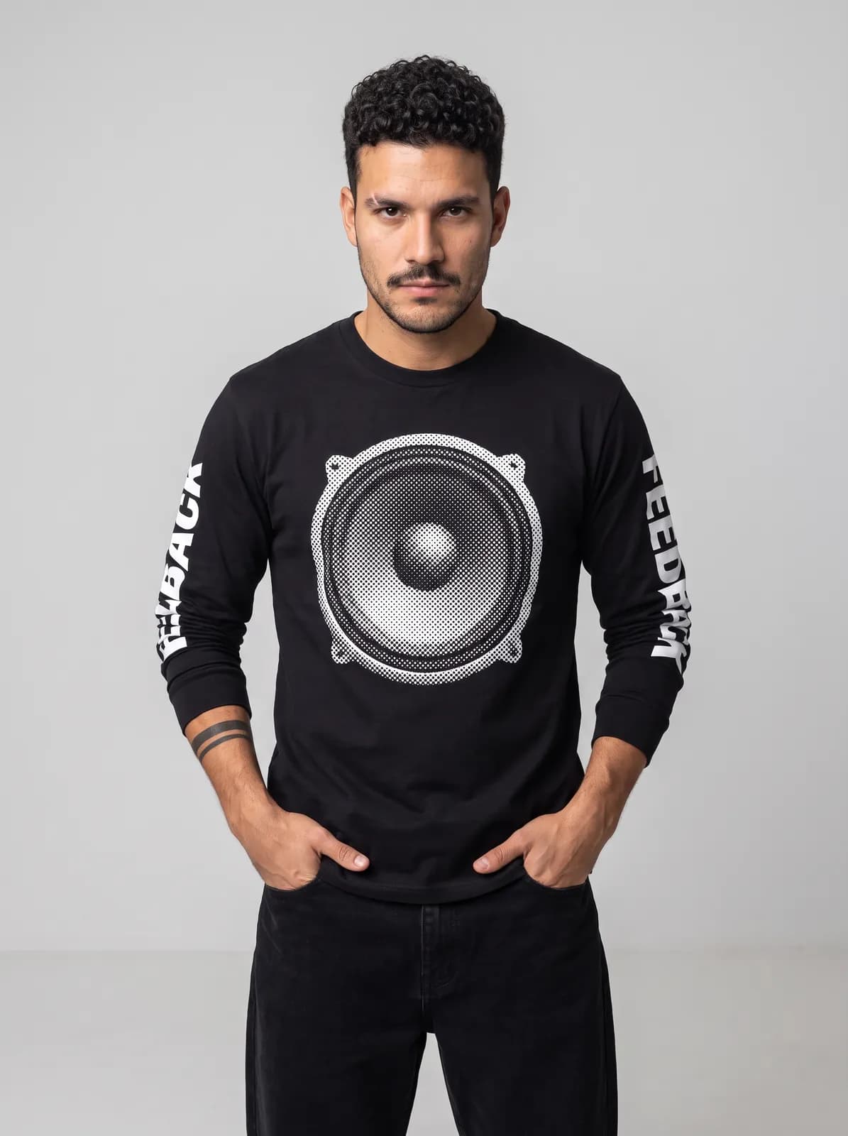 Diego Alvarez wearing the FEEDBACK Longsleeve in Black, waist up crop