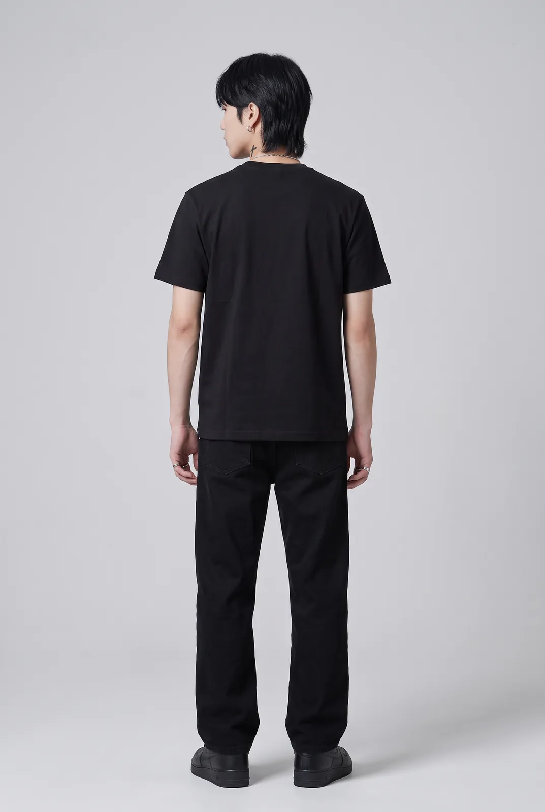 Jae Park wearing the GUTTER Tee in Black, back turn