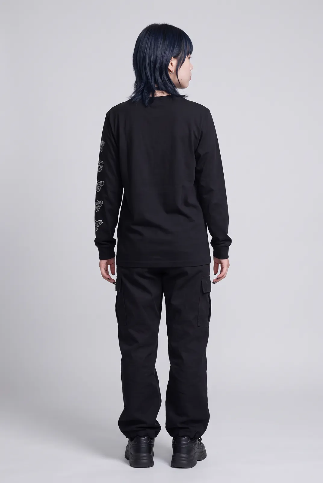 Sora Tanaka wearing the MOTH Longsleeve in Black, back turn