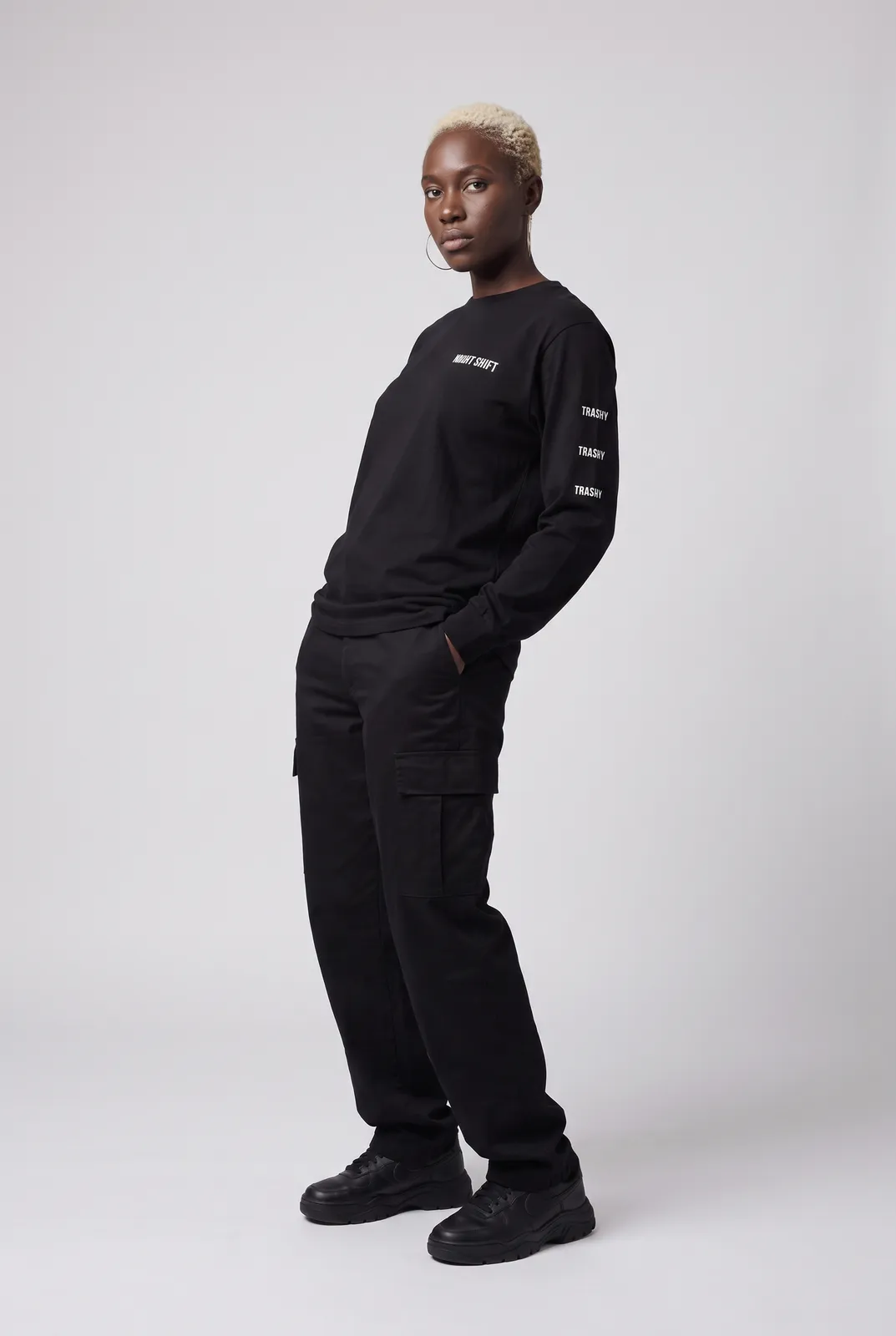 Imani Okafor wearing the NIGHT SHIFT Longsleeve in Black, three quarter lean