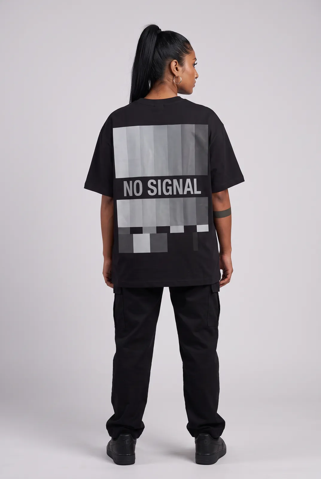 Zara Mehta wearing the NO SIGNAL Oversized in Black, back turn