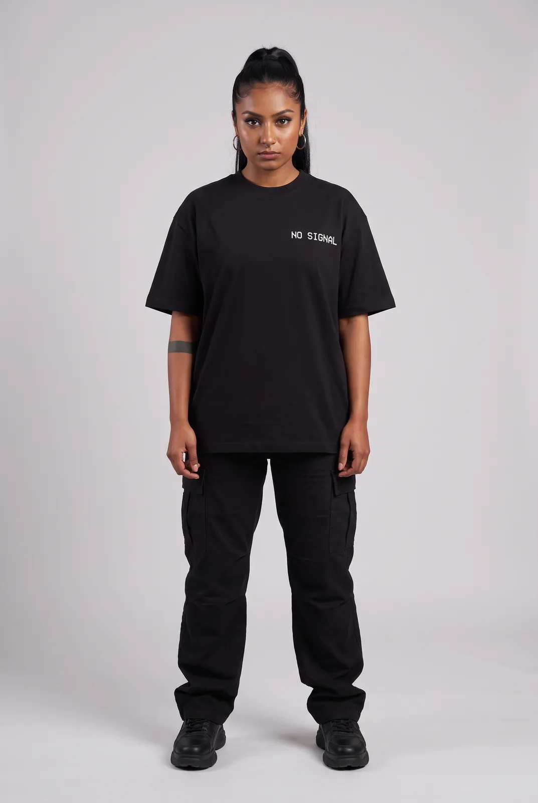 Zara Mehta wearing the NO SIGNAL Oversized in Black, front hero