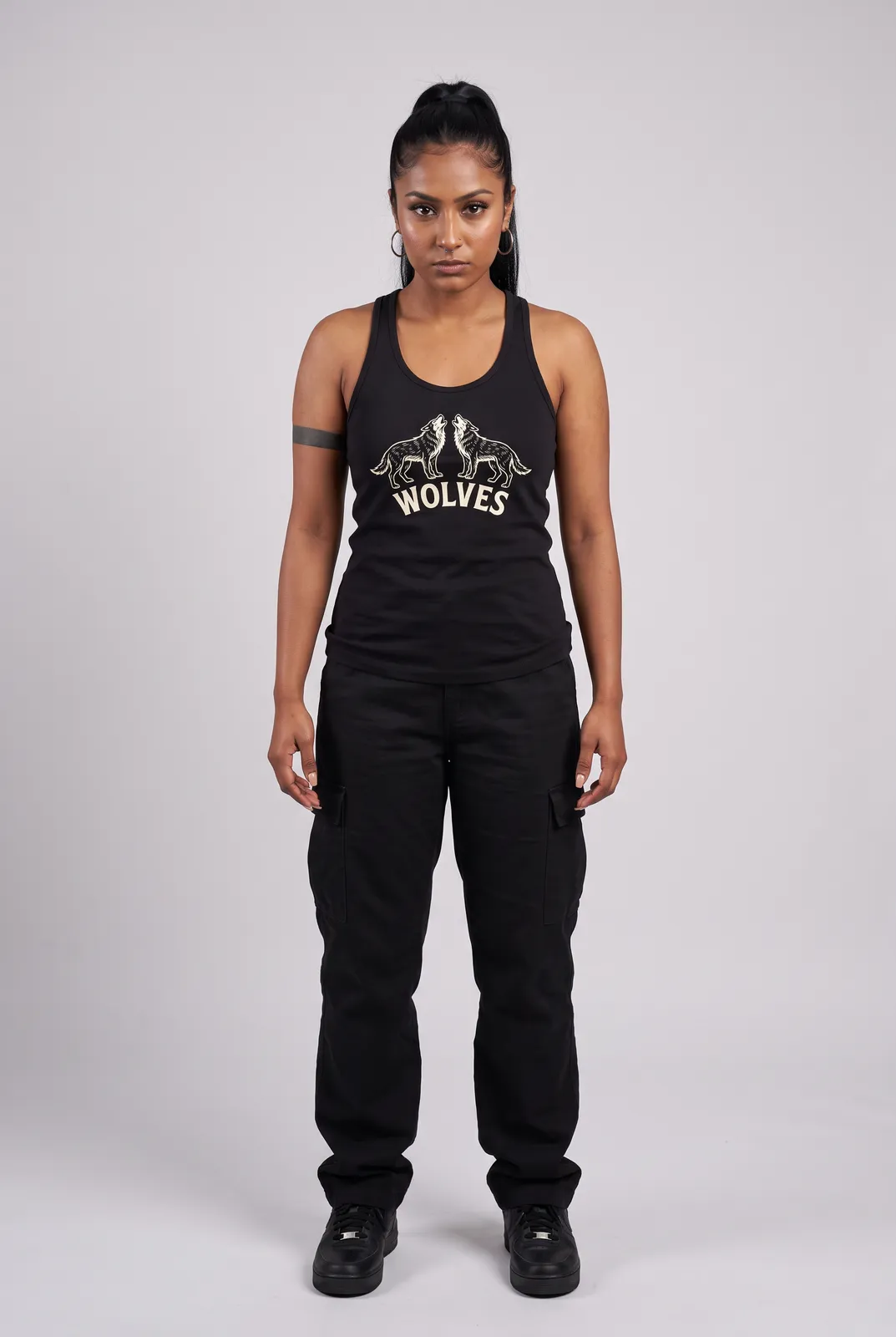 Zara Mehta wearing the WOLVES Tank in Black, front hero